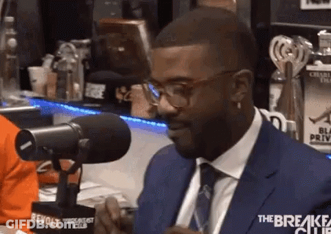 Man In Suit And Tie Talking Into Microphone With Glasses GIF