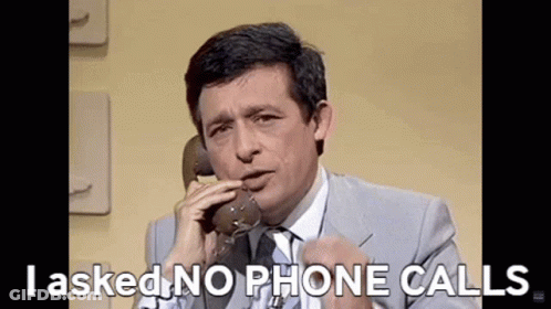 Man In Suit And Tie Talking On Phone GIF