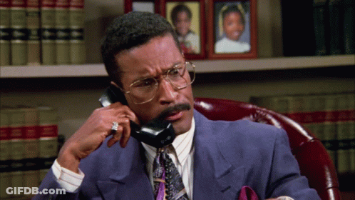 Man In Suit And Tie Talking On Phone GIF