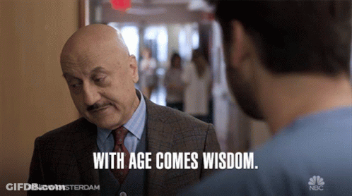 Man In Suit And Tie Talking To Another Man With Age Comes Wisdom GIF