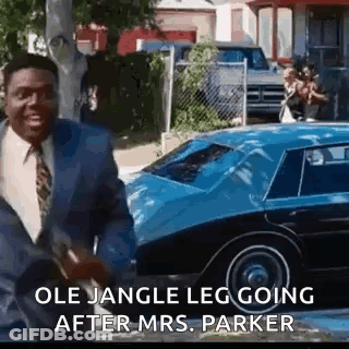 Man In Suit And Tie Talking To Blue Car GIF