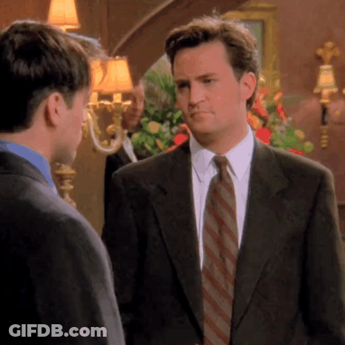 Man In Suit And Tie Talking To Man In Blue Shirt GIF