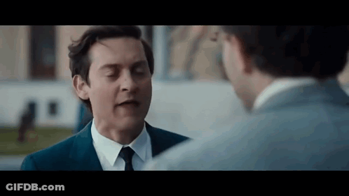 Man In Suit And Tie Talking To Man In White Shirt GIF