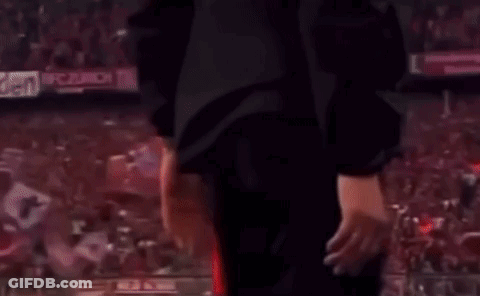 Man In Suit And Tie Talking To Red Shirt Soccer Player GIF