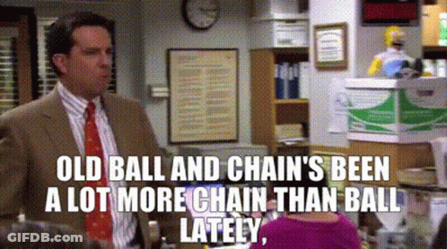 Man In Suit And Tie Talking To Woman In Pink Sweater GIF