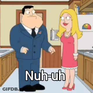 Man In Suit And Tie Talking To Woman In Red Dress In Kitchen GIF