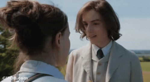 Man In Suit And Tie Talks To Woman GIF