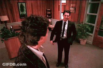 Man In Suit And Tie Talks To Woman GIF