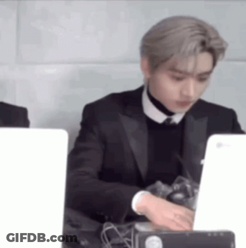 Man In Suit And Tie Using Laptop GIF