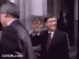 Man In Suit And Tie Walking Down Hallway GIF