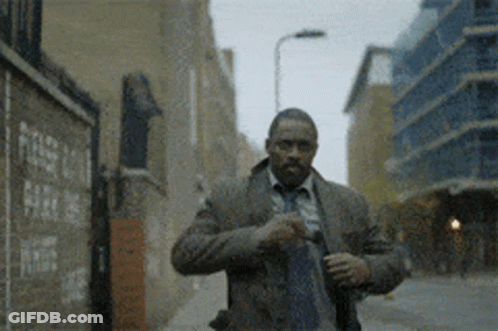 Man In Suit And Tie Walking Down Street GIF