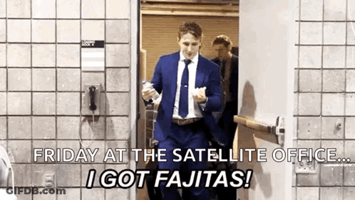 Man In Suit And Tie Walking Through Door Holding Bottle Of Water GIF