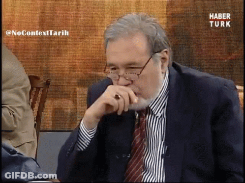 Man In Suit And Tie Watching Haber Turk GIF