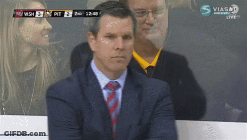 Man In Suit And Tie Watching Hockey GIF