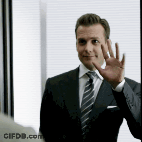 Man In Suit And Tie Waving GIF