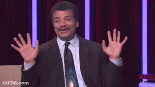Man In Suit And Tie Waving At Red Curtain GIF