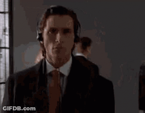 Man In Suit And Tie Wearing Headphones GIF