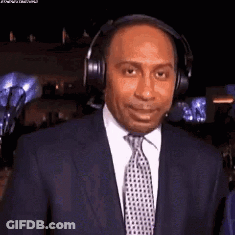 Man In Suit And Tie Wearing Headphones GIF