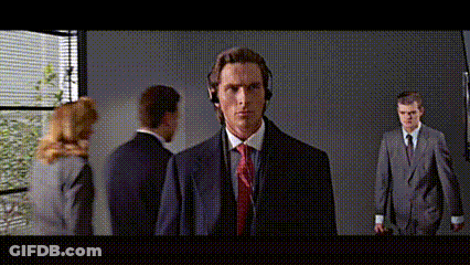 Man In Suit And Tie Wearing Headphones In Front Of Group GIF