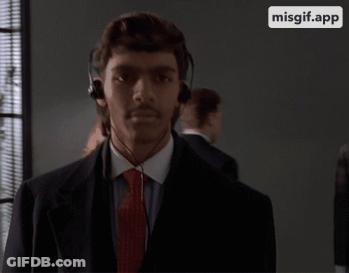 Man In Suit And Tie Wearing Headphones GIF
