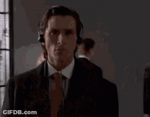 Man In Suit And Tie Wearing Headphones GIF
