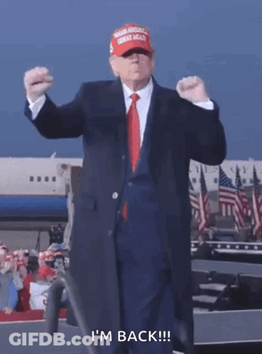 Man In Suit And Tie Wearing MAGA Hat Says I'm Back GIF