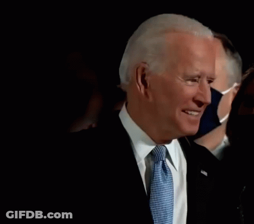 Man In Suit And Tie Wearing Mask GIF