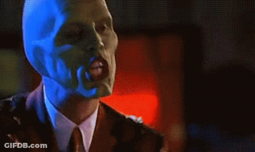 Man In Suit And Tie Wearing Mask GIF