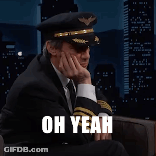 Man In Suit And Tie Wearing Pilot Hat GIF