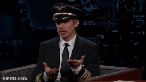 Man In Suit And Tie Wearing Pilot Hat GIF