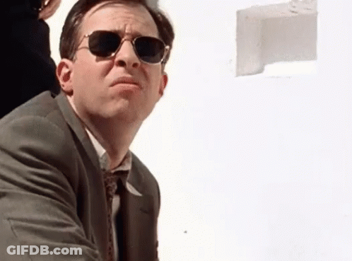 Man In Suit And Tie Wearing Sunglasses Looking Up GIF