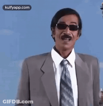 Man In Suit And Tie Wearing Sunglasses Pointing GIF