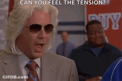 Man In Suit And Tie Wearing Sunglasses Saying Can You Feel The Tension GIF