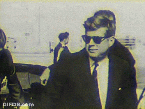 Man In Suit And Tie Wearing Sunglasses Walking GIF