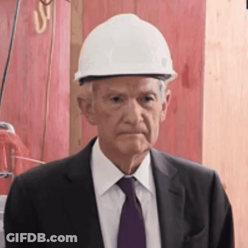 Man In Suit And Tie Wearing White Hard Hat GIF