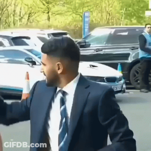 Man In Suit And Tie With Arms Outstretched GIF