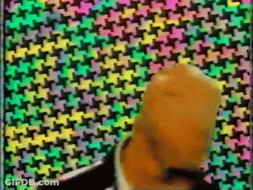 Man In Suit And Tie With Colorful Geometric Pattern GIF