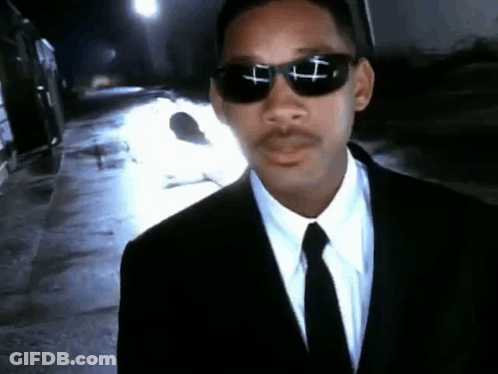 Man In Suit And Tie With Cross Sunglasses GIF