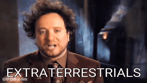 Man In Suit And Tie With Extraterrestrials GIF