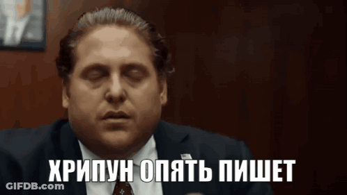 Man In Suit And Tie With Foreign Language On Face GIF