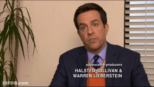 Man In Suit And Tie With Halsted Sullivan And Warren Lieberstein GIF