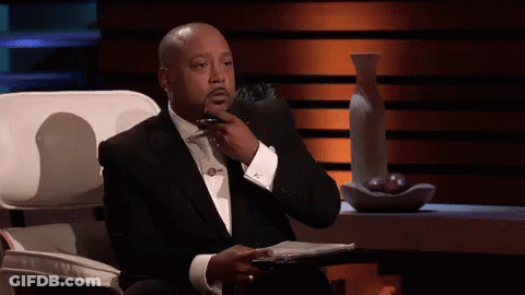 Man In Suit And Tie With Hand On Chin GIF