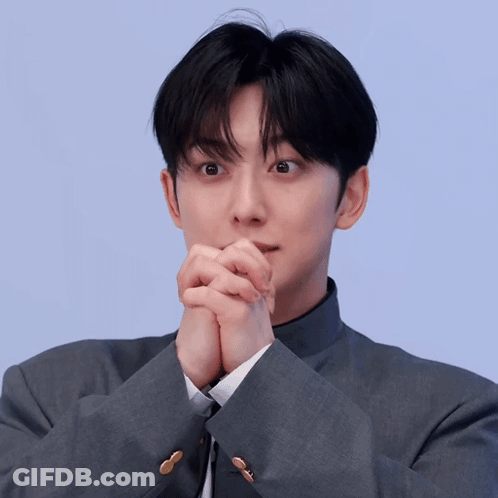Man In Suit And Tie With Hands Folded Covering Mouth GIF