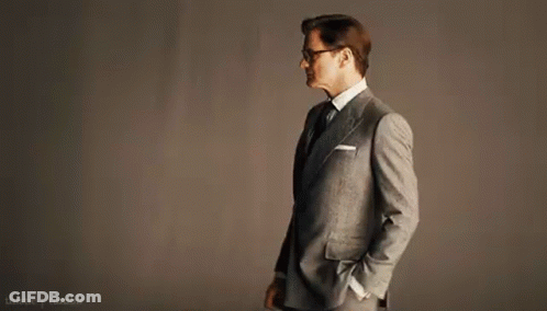 Man In Suit And Tie With Hands In Pockets And Glasses GIF