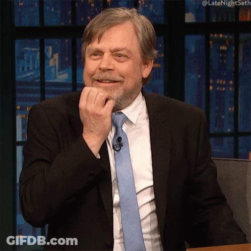 Man In Suit And Tie With Hashtag Latenightseth GIF