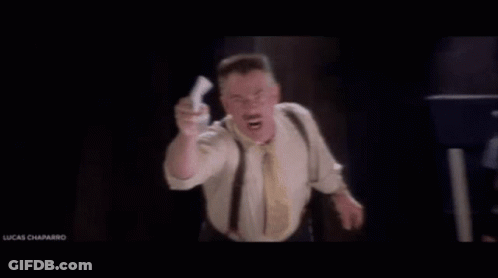 Man In Suit And Tie With He's Back Sign GIF