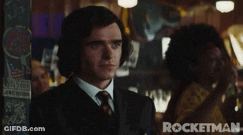 Man In Suit And Tie With Headphones In Bar GIF