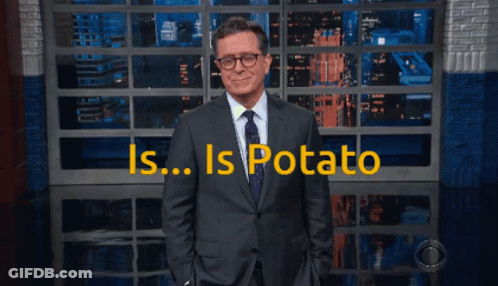 Man In Suit And Tie With Is Potato Sign GIF