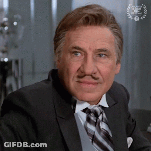Man In Suit And Tie With Laurel Wreath GIF