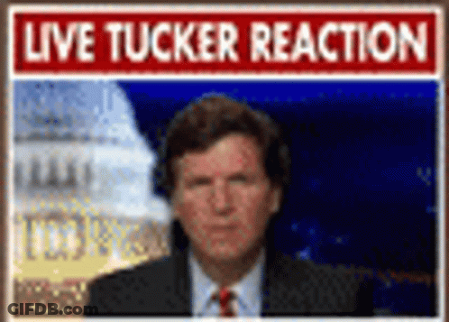 Man In Suit And Tie With Live Tucker Reaction Sign GIF